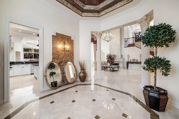 Formal dining area with marble flooring with inlay detail, decorative ceiling with intricate molding with faux painting