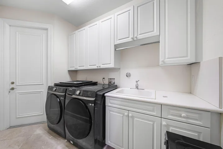 Laundry Room with ample storage, access to 2 car main garage