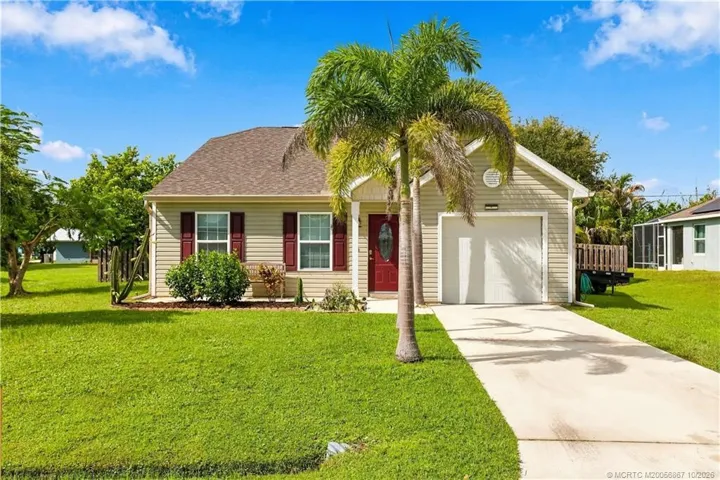 Alternate view of front elevation showing driveway and palm tree landscaping