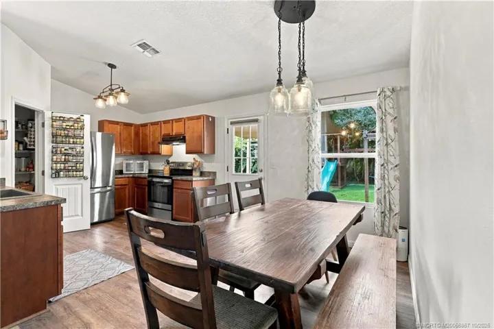 Dining space with table seating and pendant lighting