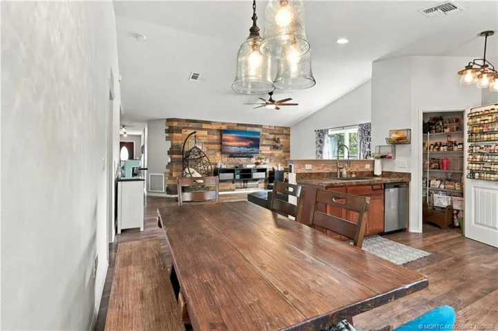 Dining space with table seating and pendant lighting
