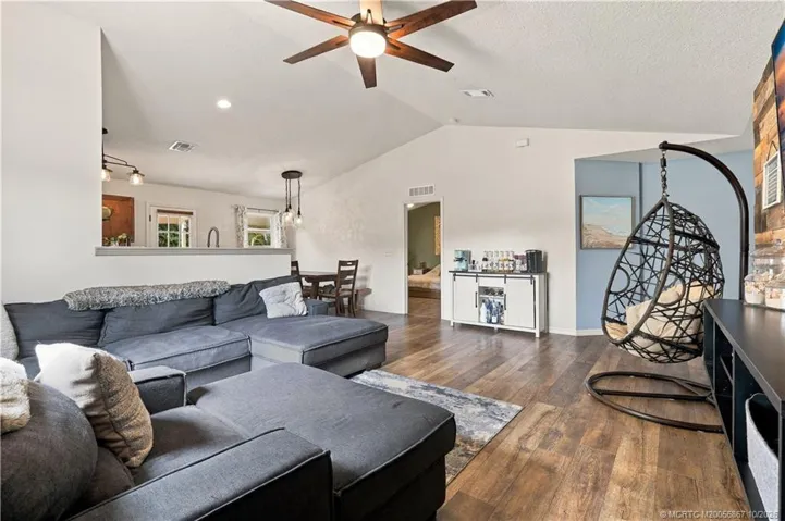 Living room with open-concept sightline to kitchen