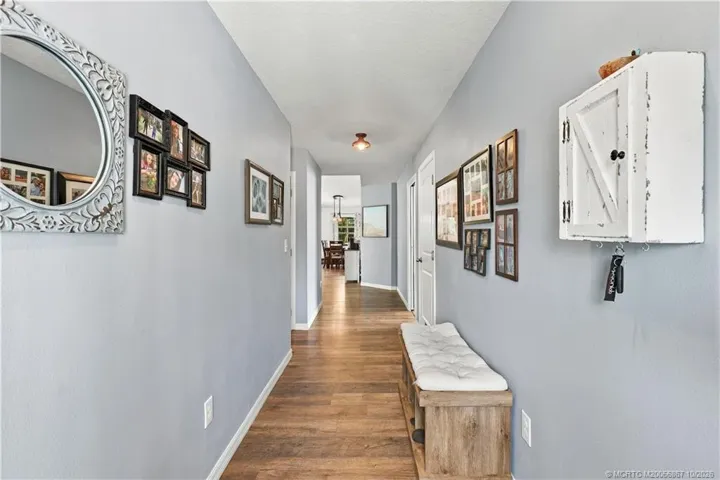 Foyer entry with wood-look flooring leading into main living space