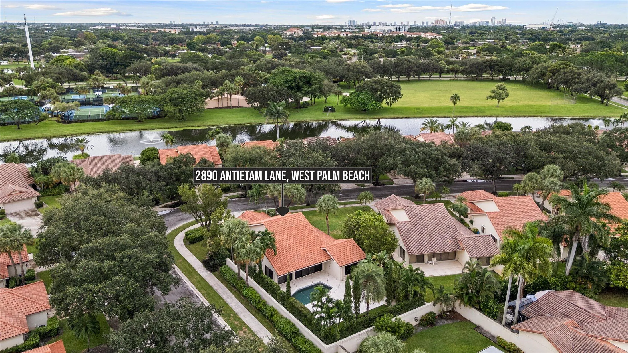 Residence with tiled roof, private swimming pool, and mature landscaping