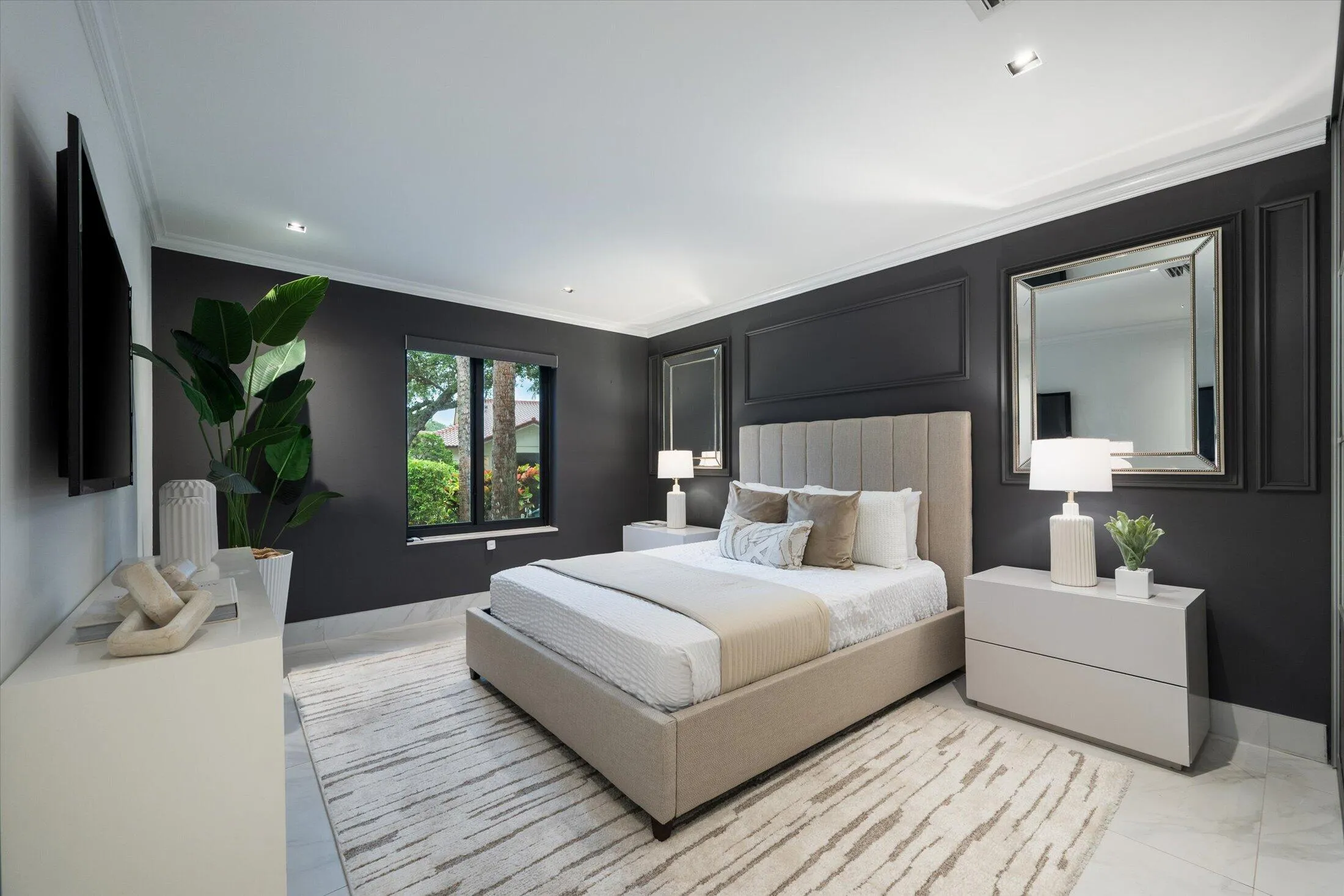 Recessed lighting, crown molding, a window with exterior views, and a paneled accent wall