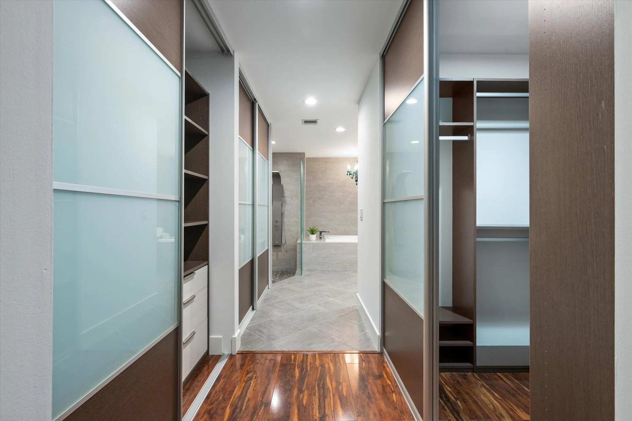 Wood-finish flooring leading to a hallway with built-in storage