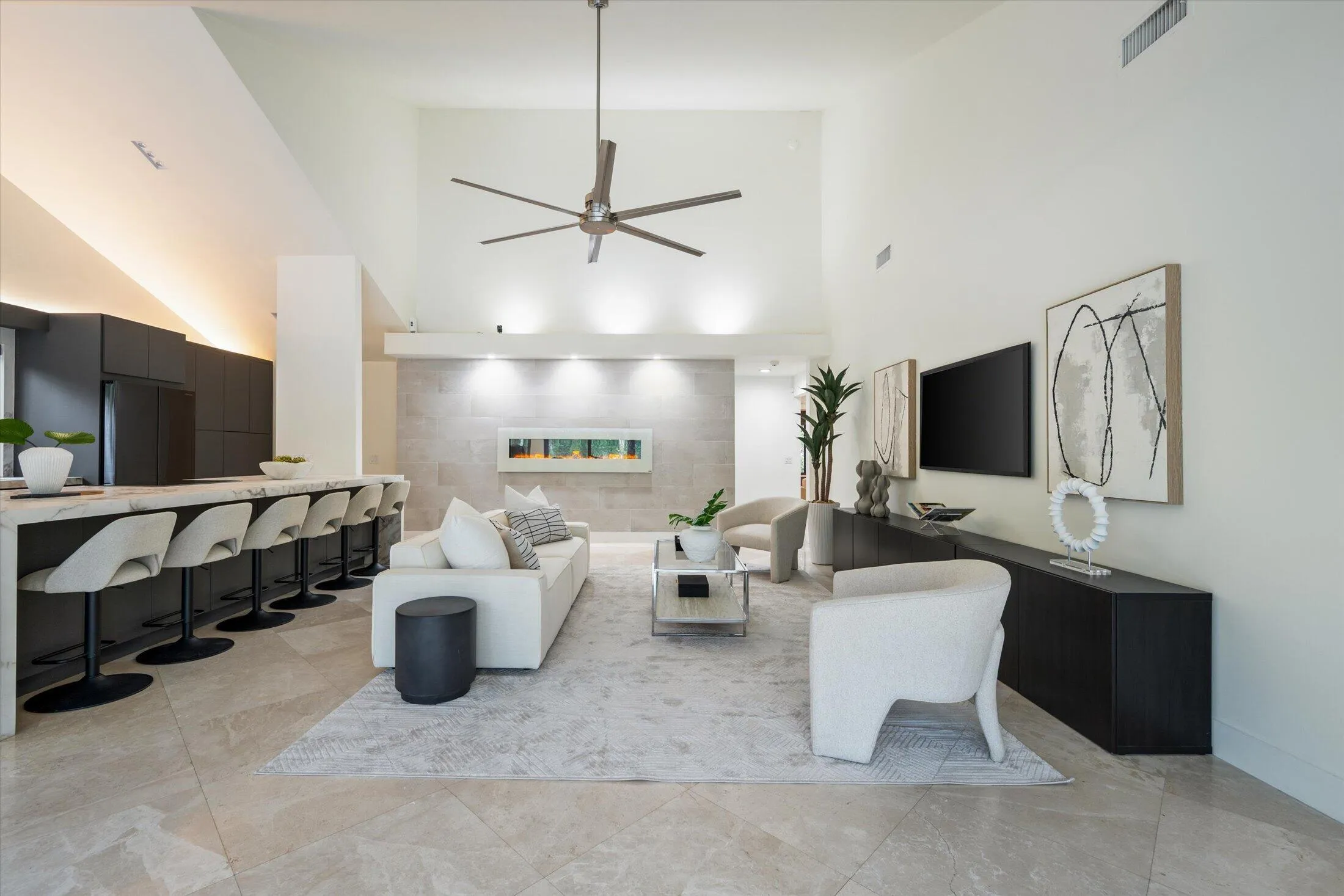 Vaulted ceiling, ceiling fan, built-in electric fireplace, recessed lighting, and tile flooring