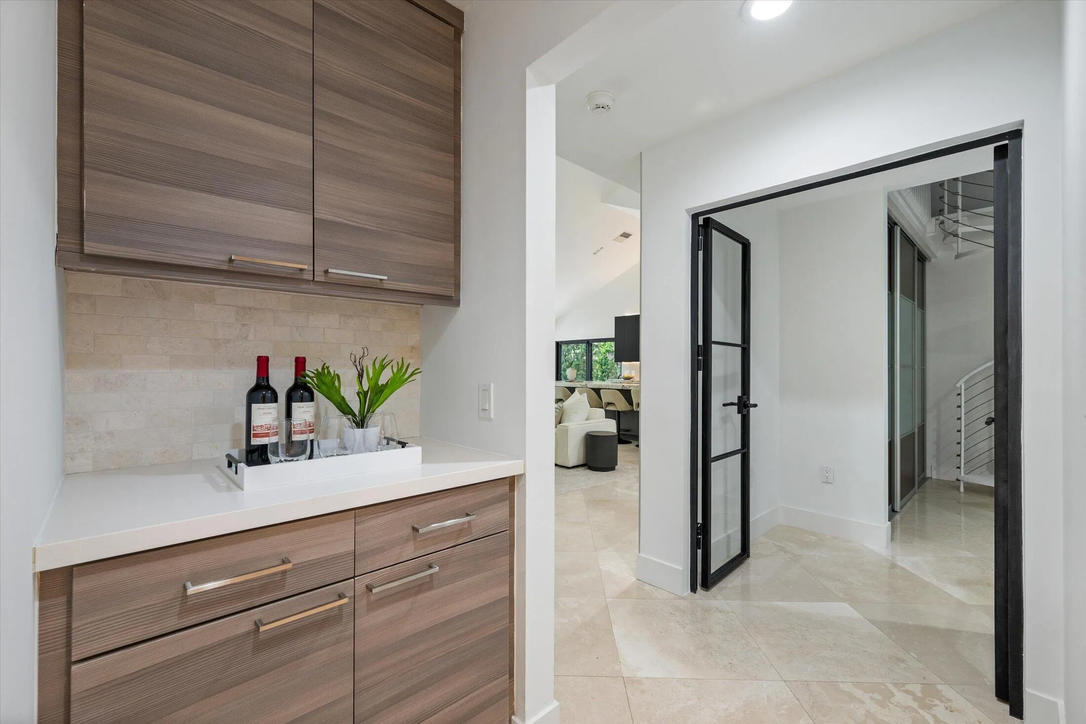 Built-in cabinetry with wood-finish fronts, light-toned countertop, and tiled backsplash