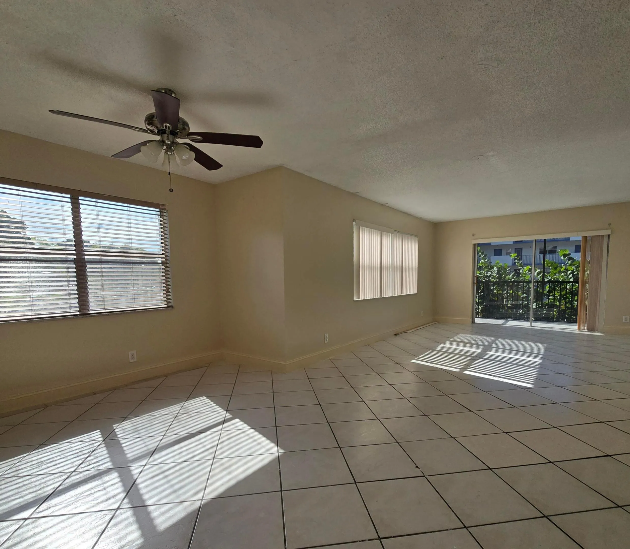 Spacious room with large tile flooring.