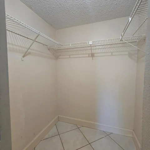 1 of 2 walk-in closets in primary bedroom