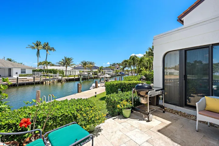 Back patio with panoramic water views steps from freshwater boat slip.