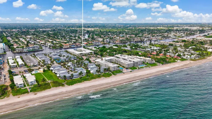 Coastal community with direct beach access, featuring waterfront properties and surrounding waterways