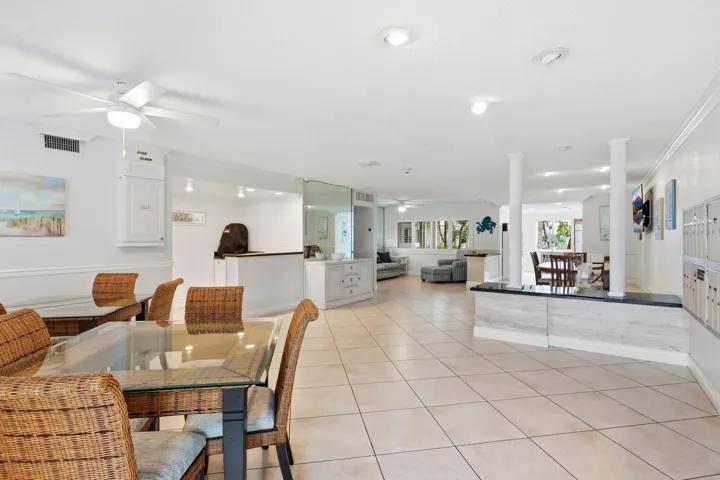 Expansive tiled flooring throughout, featuring recessed lighting and ceiling fans