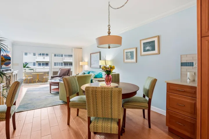 Wood-finish flooring throughout, bright recessed lighting, and a private outdoor balcony with sliding glass doors