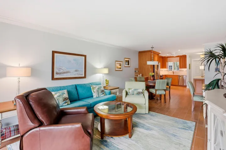 Hardwood-finish flooring throughout, crown molding, and a kitchen featuring wood cabinetry