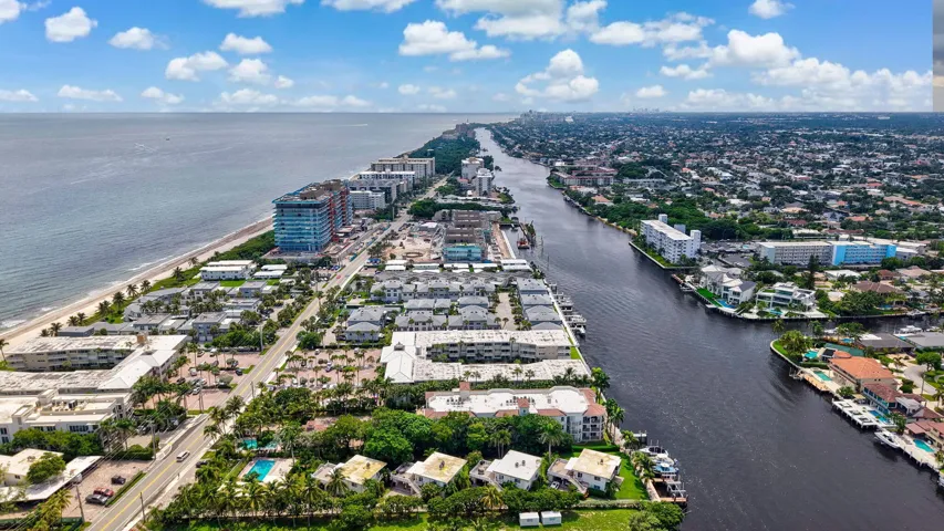 Coastal area featuring beachfront properties, a navigable waterway, and residential neighborhoods