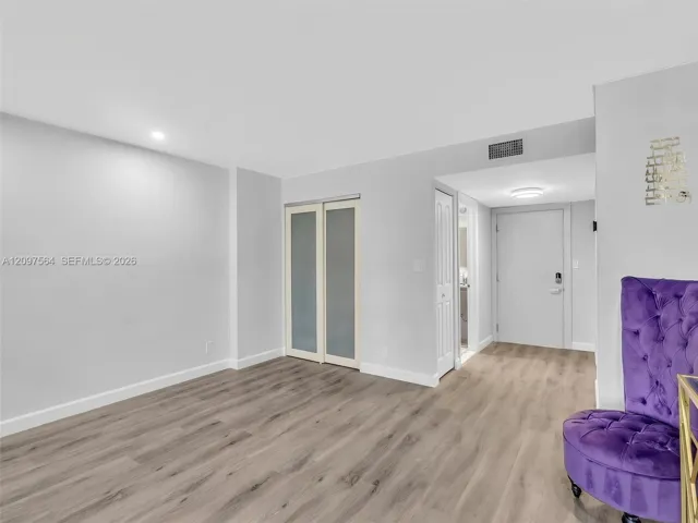 Wood-finish flooring, sliding glass-panel closet doors, and recessed lighting