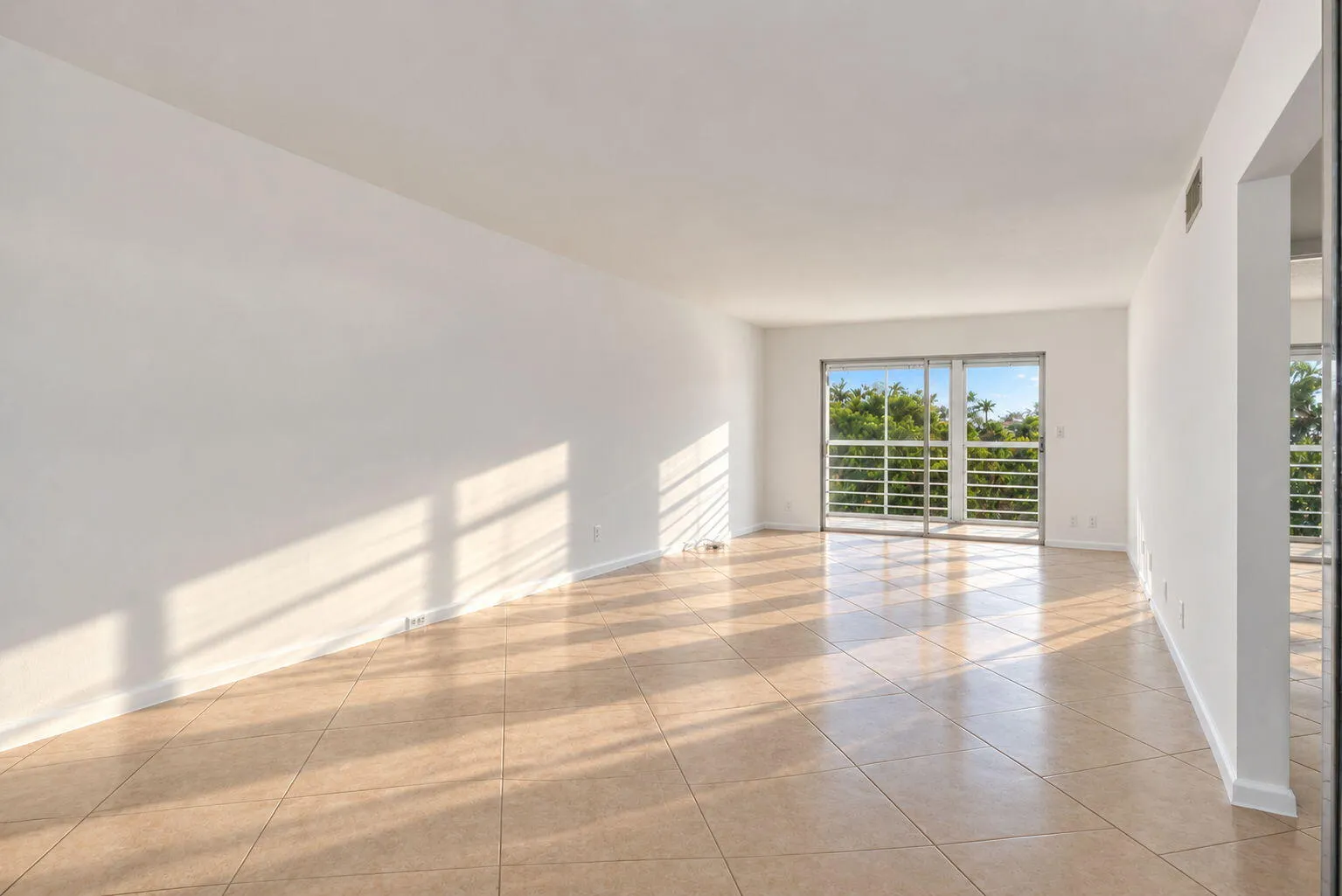 White walls with large format tile flooring throughout