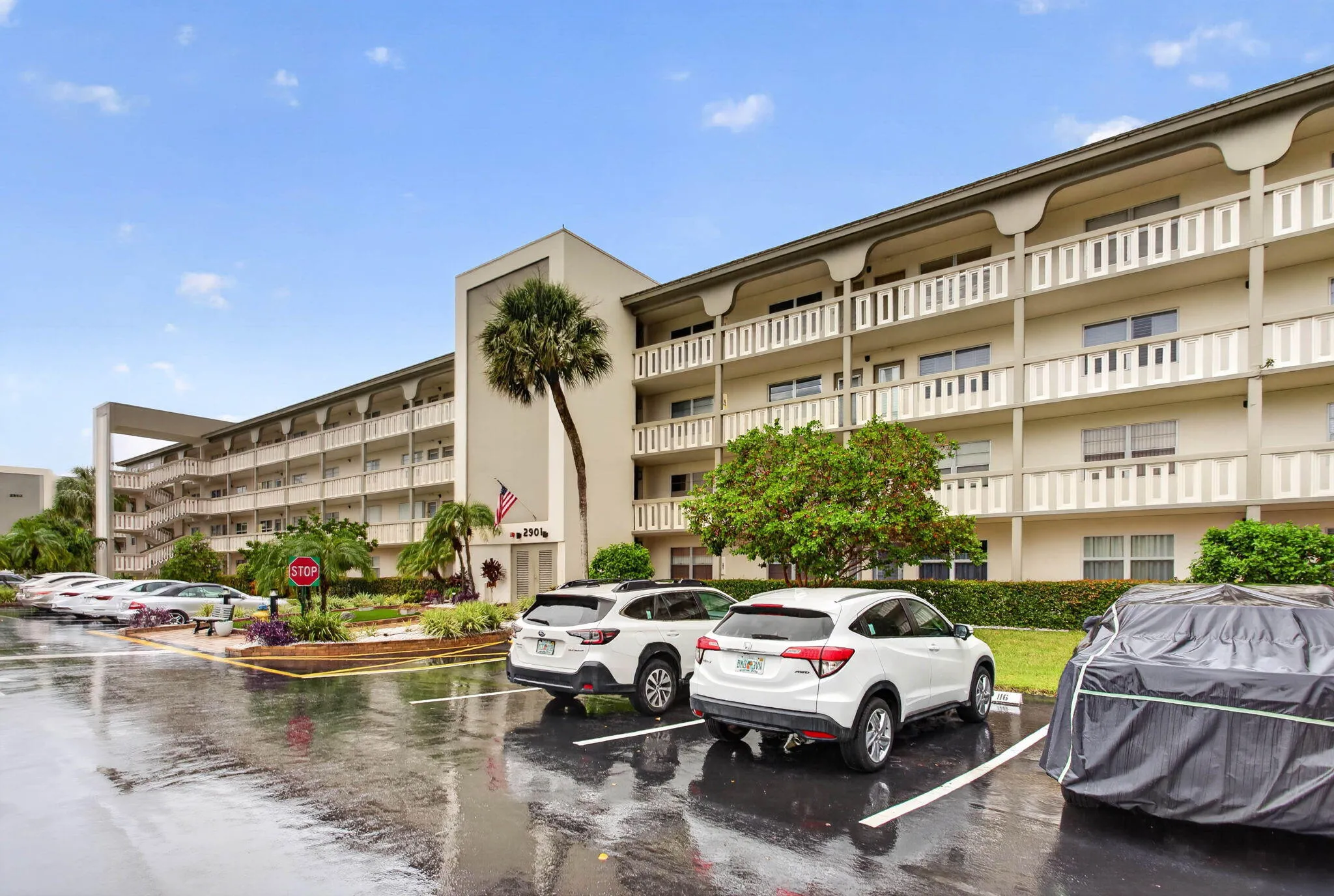 Multi-story residential building with private balconies and exterior walkways