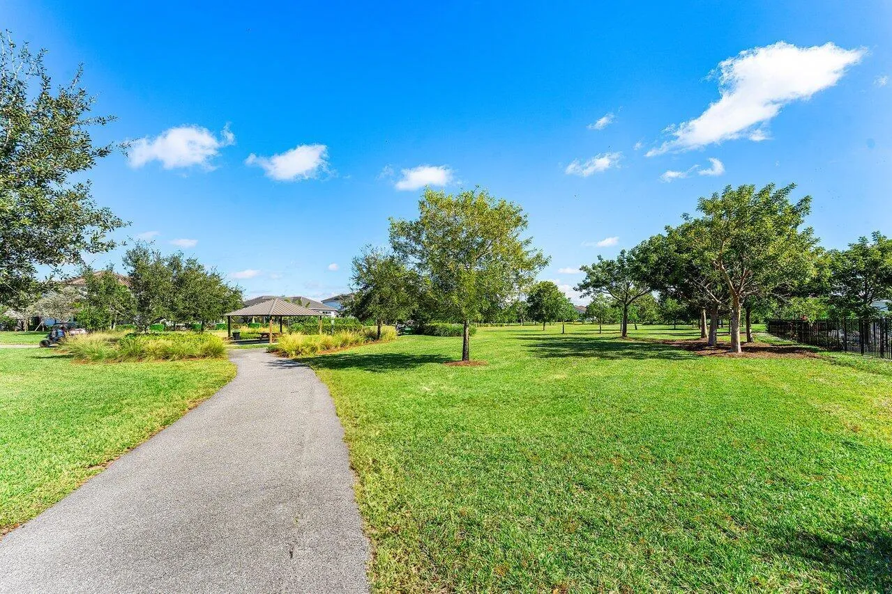 Lush corner-lot walkway with trees