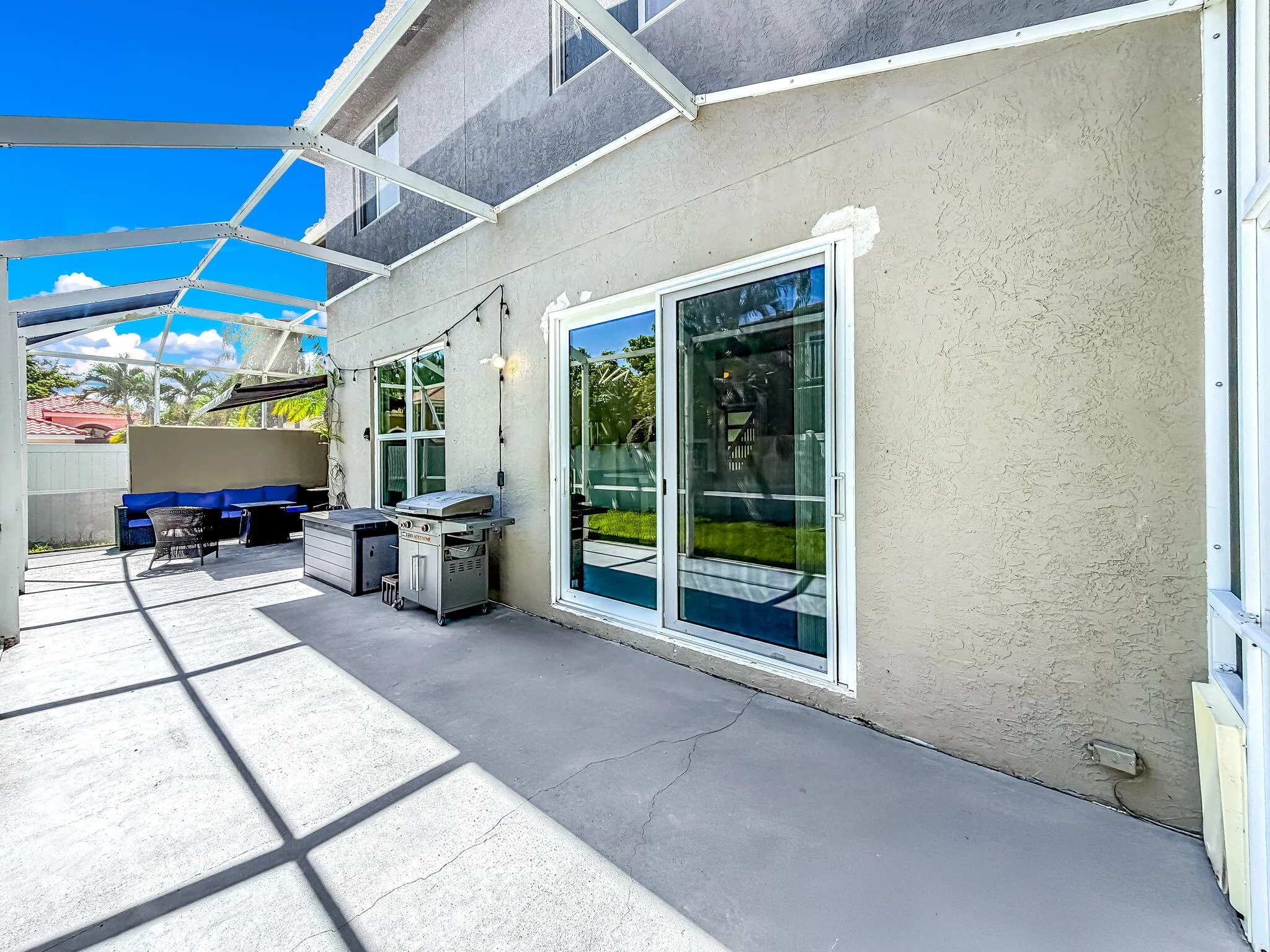Screened patio enclosure with concrete flooring