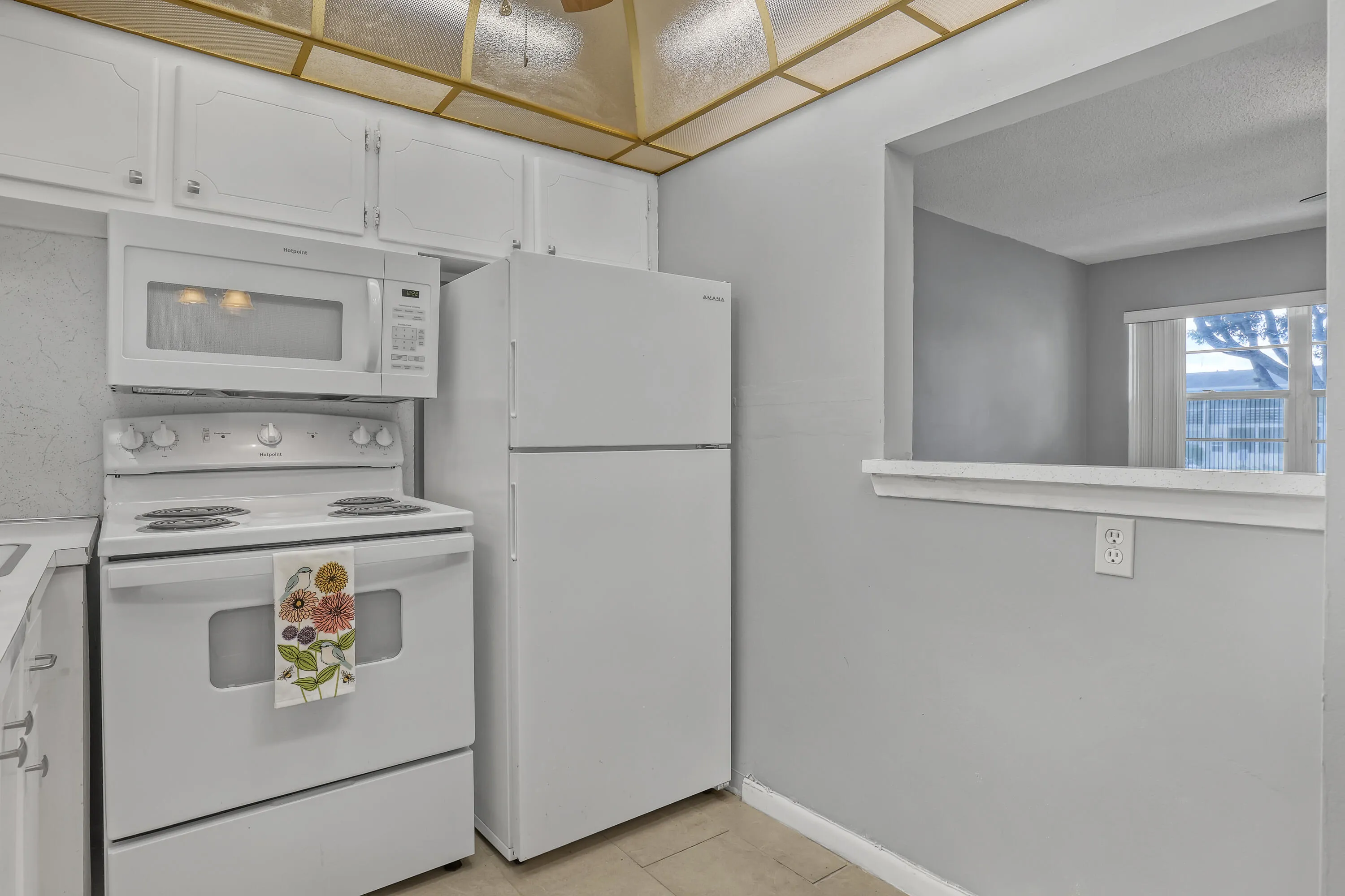 The pass-through keeps the kitchen connected to the main living area.