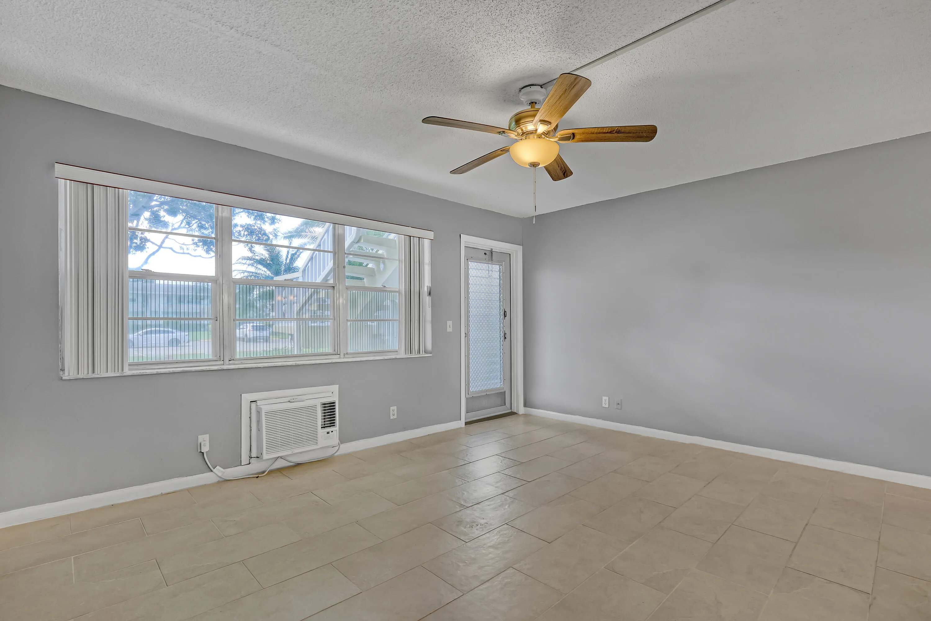 Large windows bring in natural light, and the ceiling fan helps keep you cool.