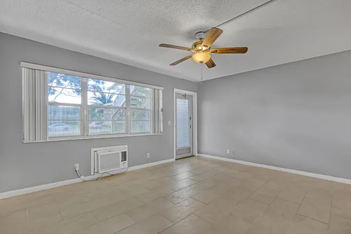 Large windows bring in natural light, and the ceiling fan helps keep you cool.