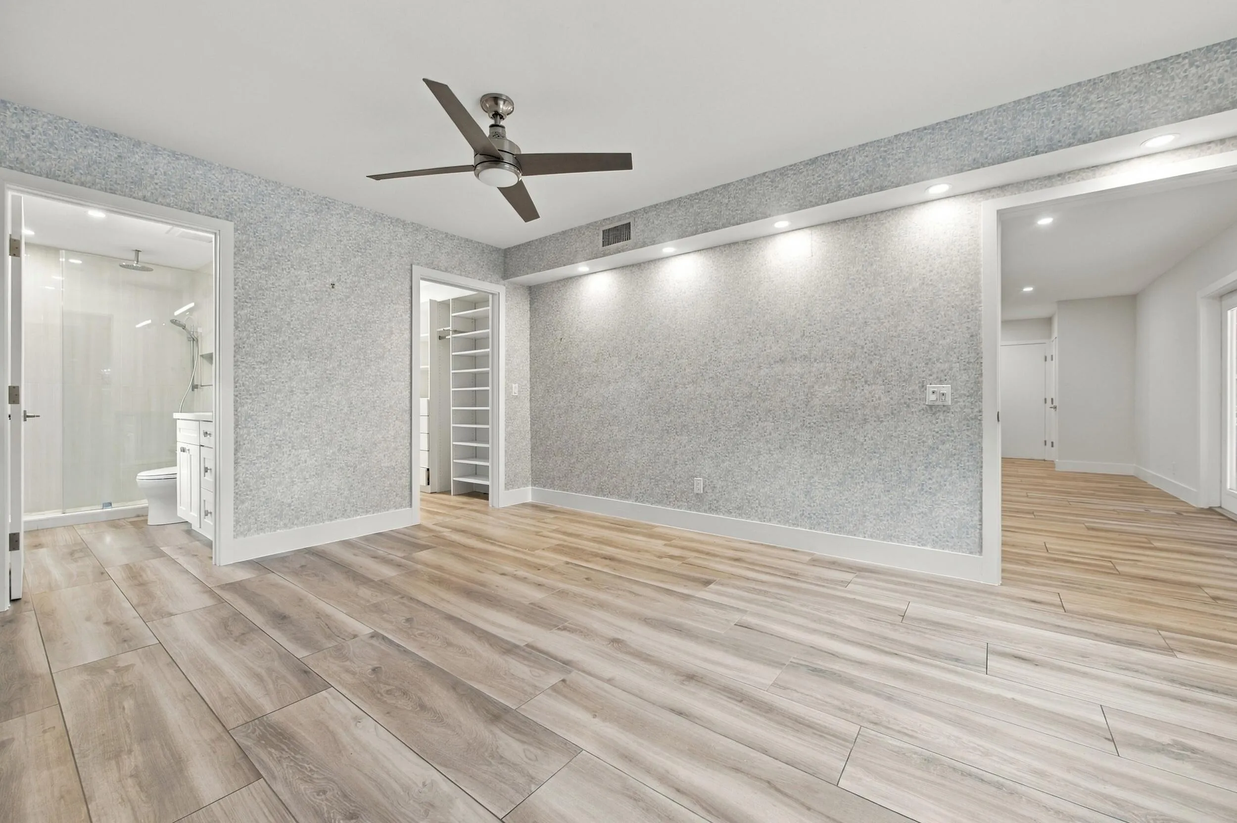 Wood-finish flooring throughout, ceiling fan, recessed lighting, and a built-in closet system