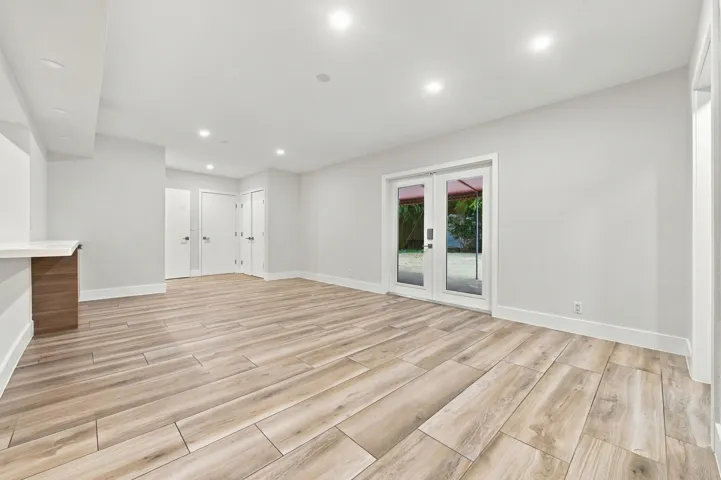 Recessed lighting, wood-finish flooring, built-in counter, and double French doors