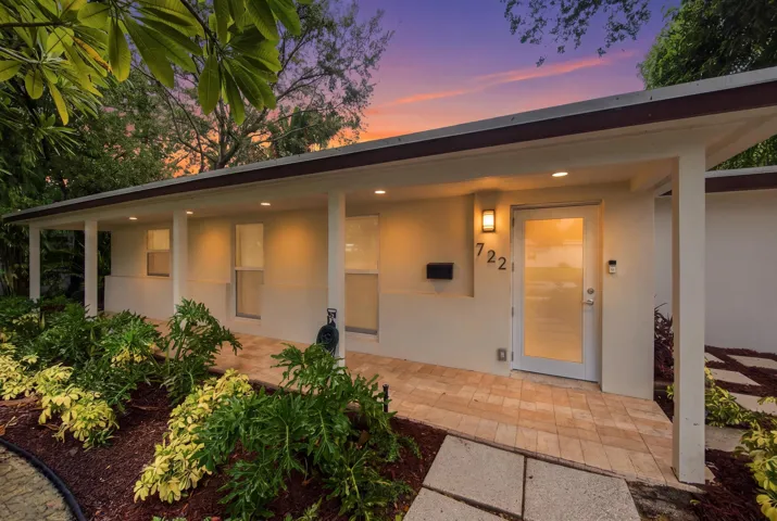 Exterior featuring a covered entry, recessed lighting, wall-mounted light fixture, decorative house numbers, and a frosted glass entry door