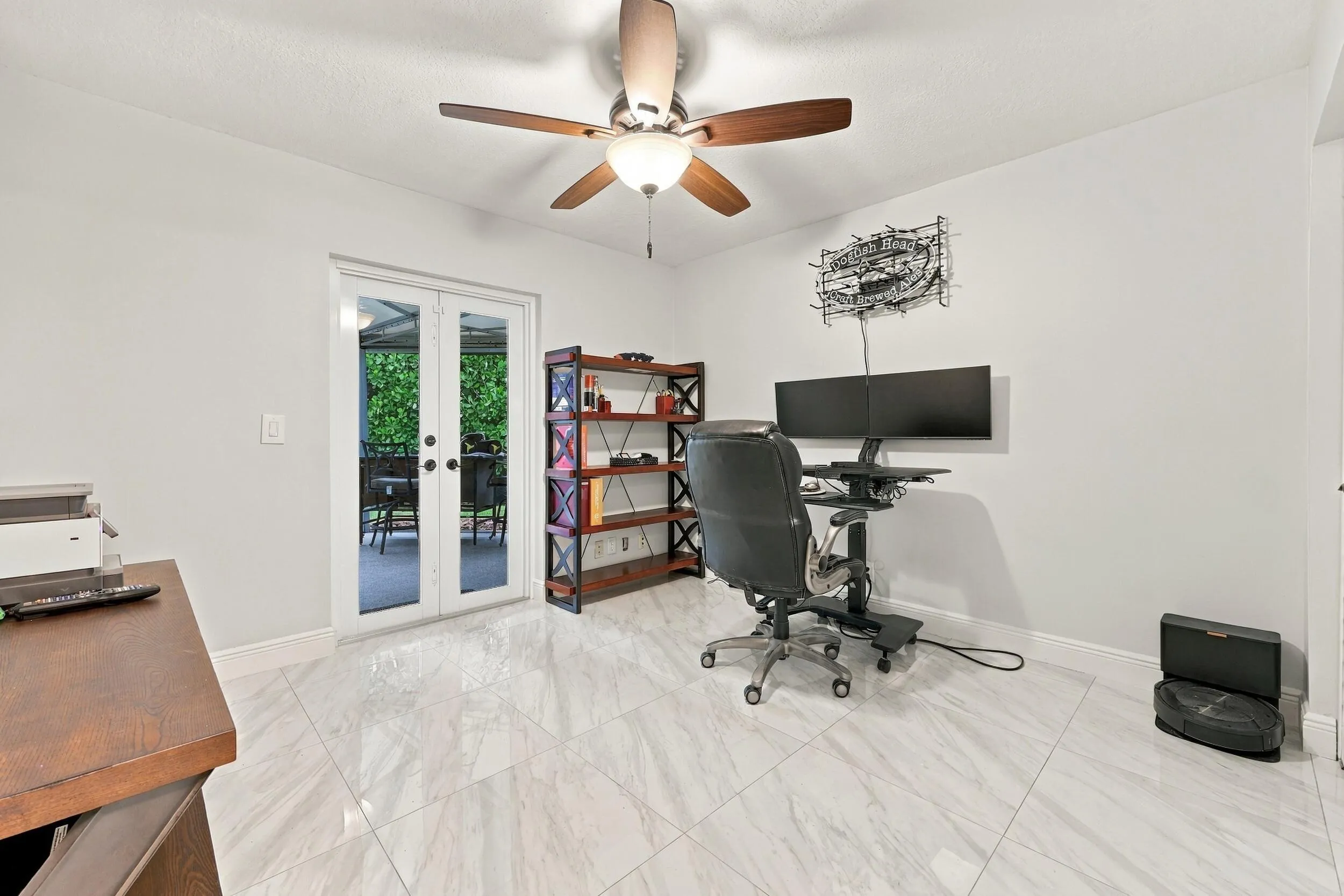 Guest bedroom 2 is spacious, with an abundance of natural light coming through the hurricane-impact French doors that lead to the 900-square-foot covered and screened-in patio.