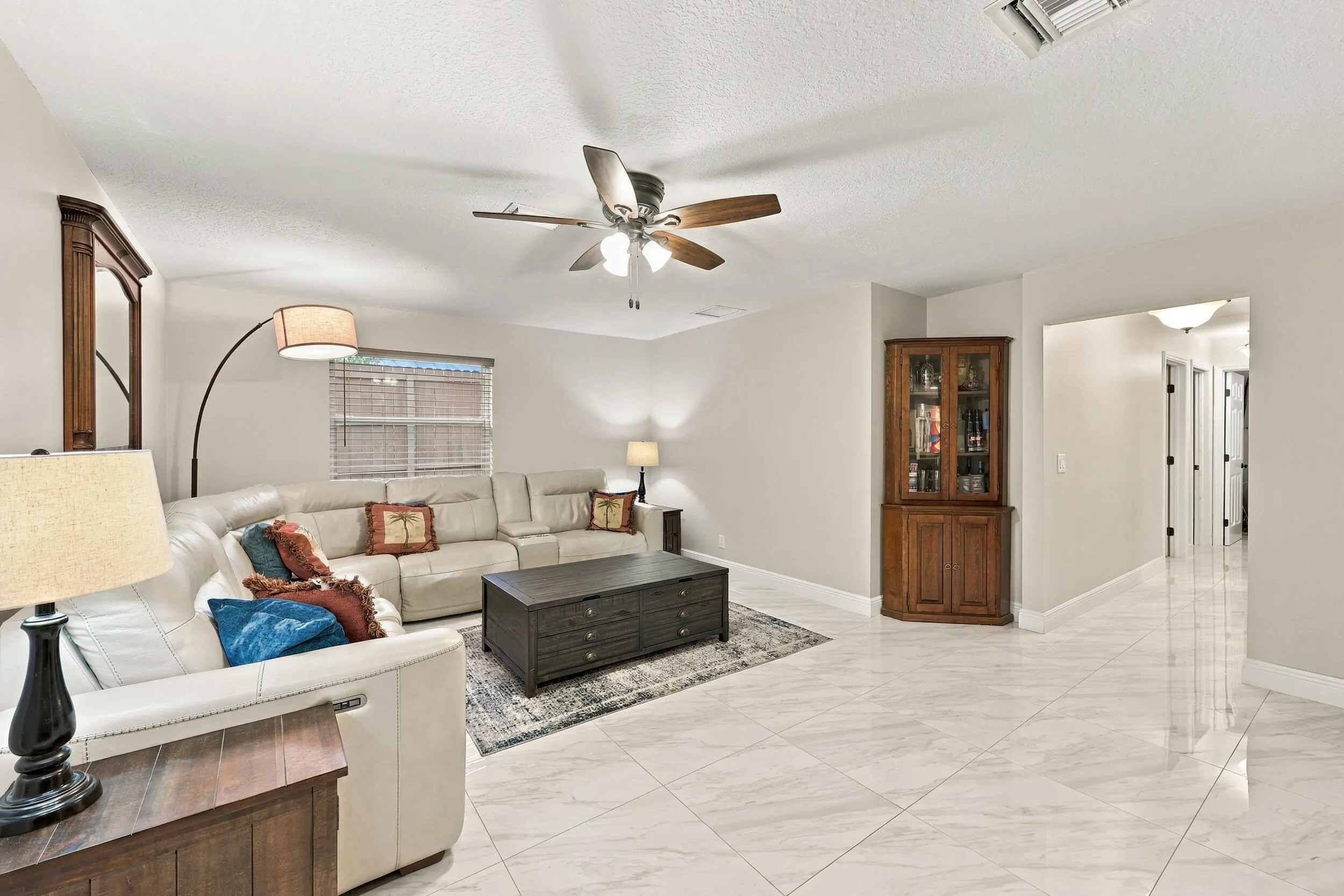 The family room is a versatile space for children of all ages. Relax and enjoy a separate area away from the kitchen and formal living room that also provides direct access through sliding glass doors to the covered patio and one-of-a-kind backyard. Down the hallway are three guest bedrooms and two full bathrooms.