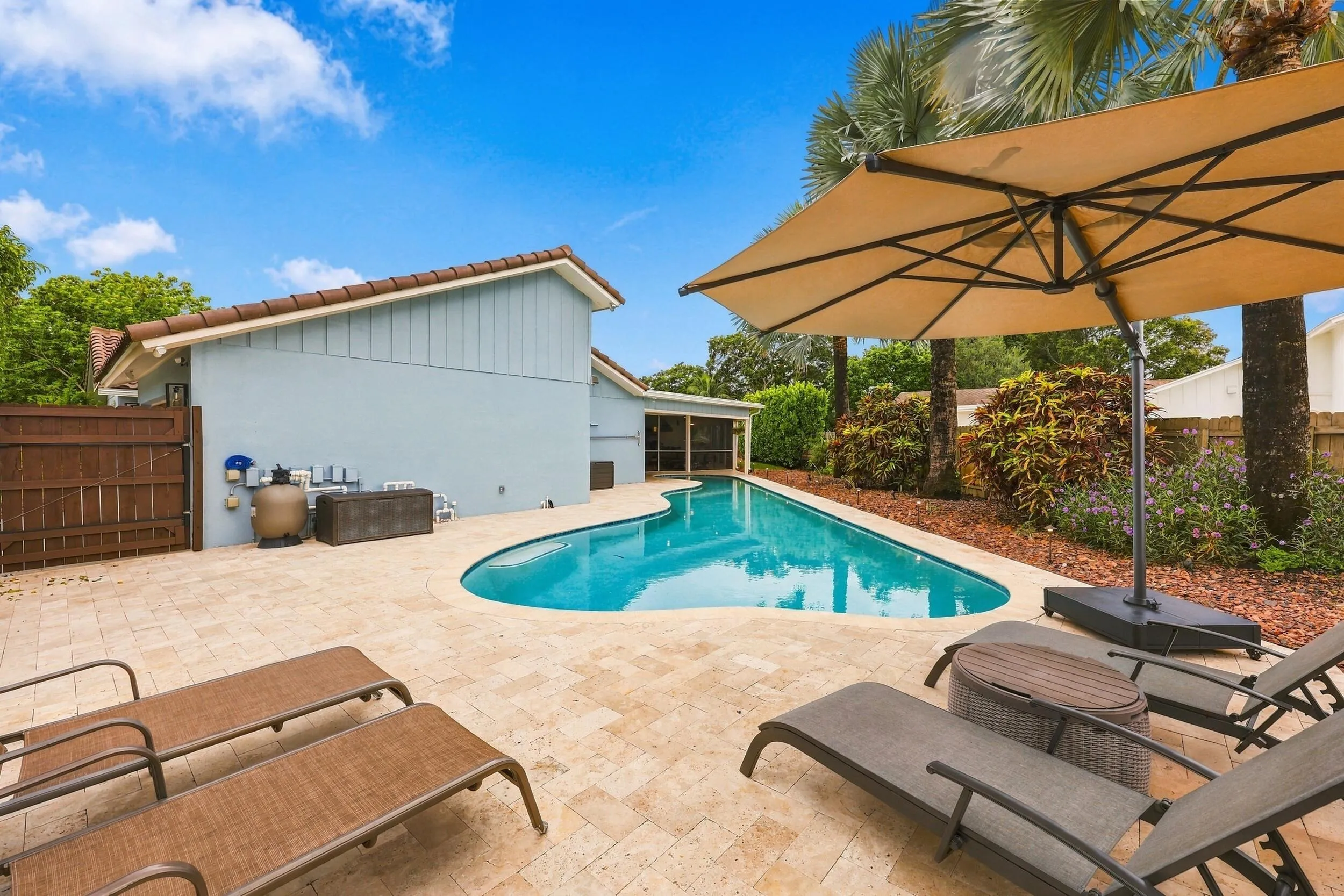 The resort-style pool starts underneath the roof line and expands down the oversized lot. Swim Olympic laps in your own backyard.