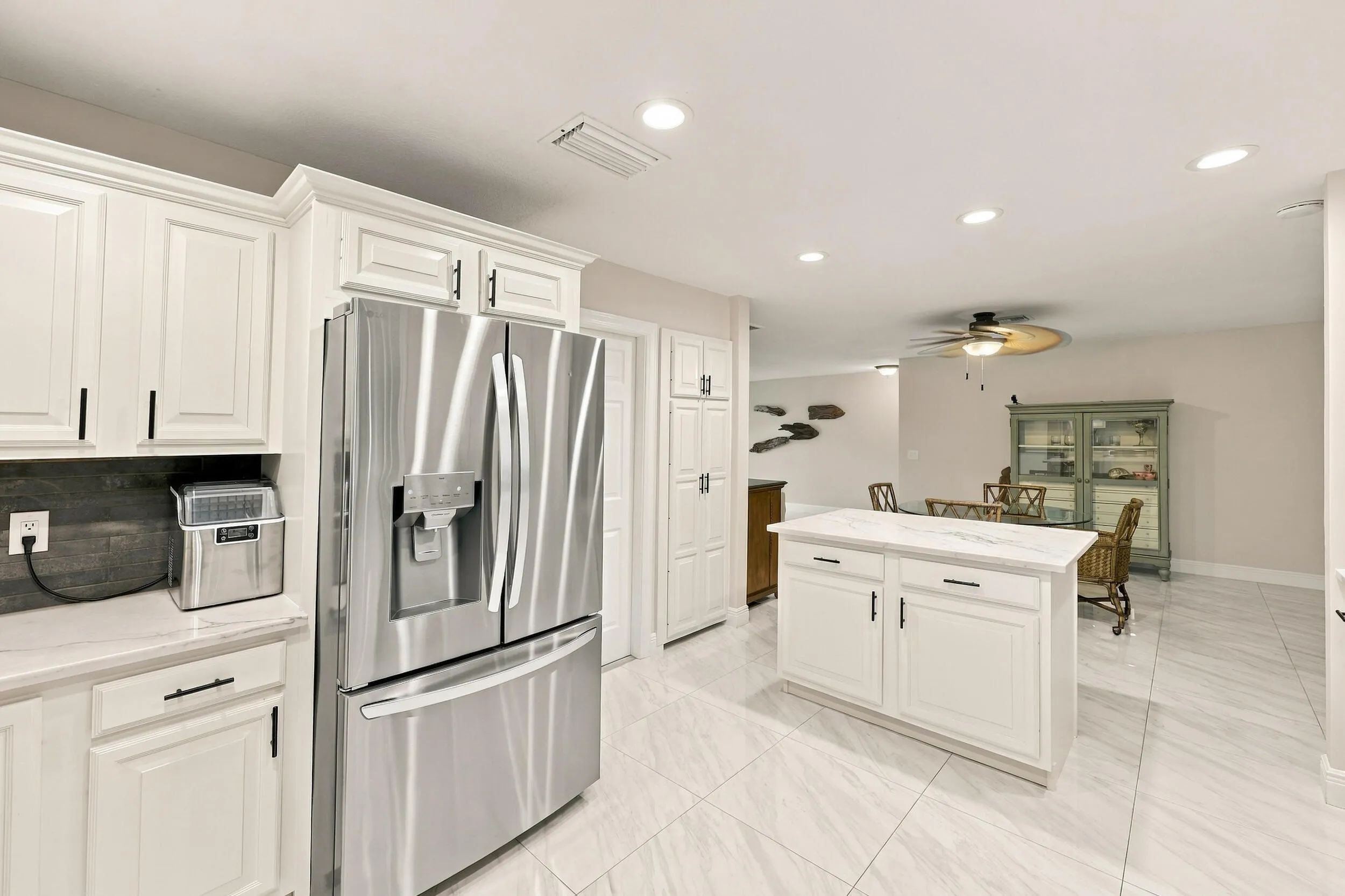 The impeccably upgraded kitchen offers white cabinetry, quartz countertops, stainless steel appliances, and a beautiful charcoal backsplash. There is tons of storage and counter space for even the most discerning chef.