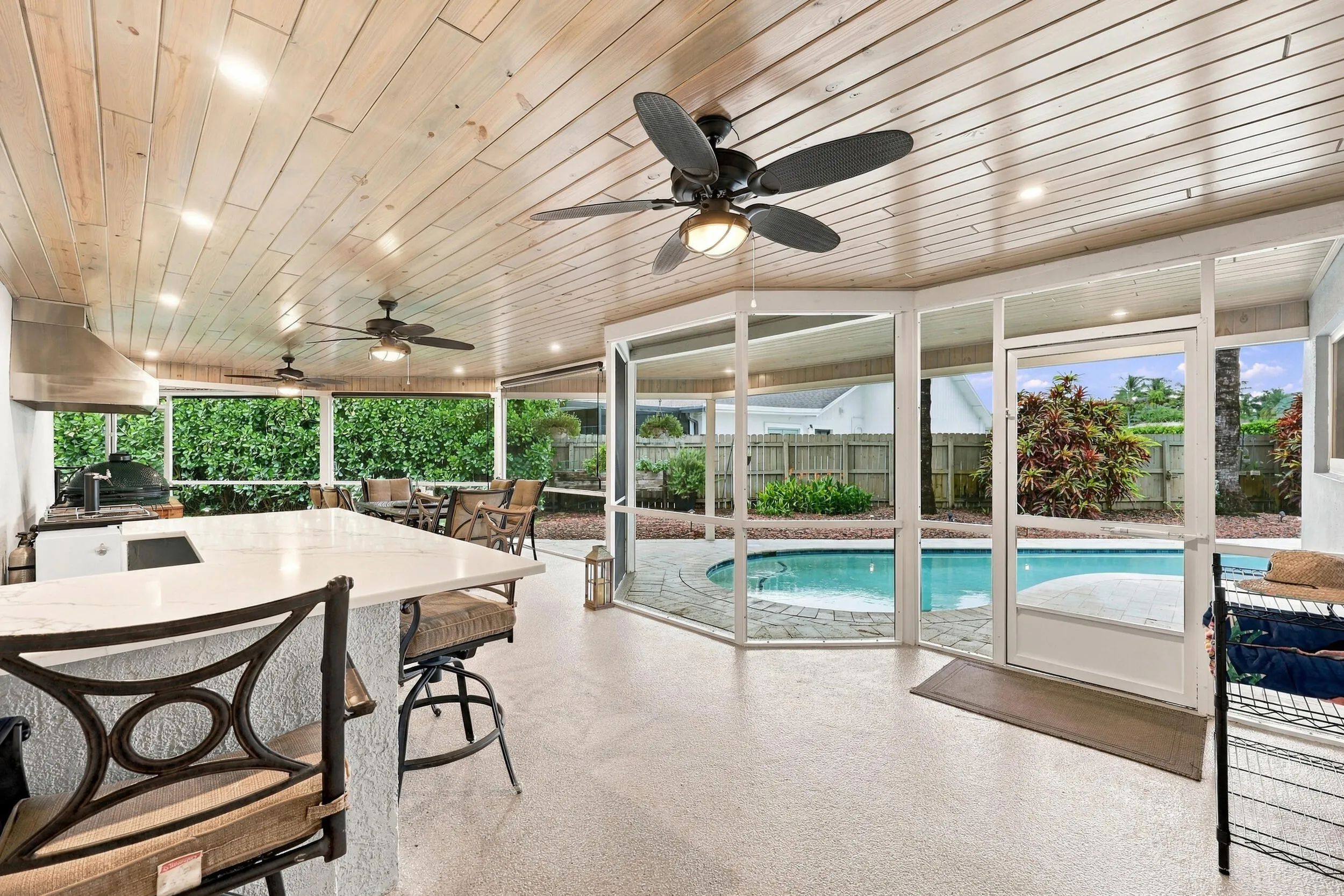 Live the epitome of the South Florida lifestyle with this 900 sq. ft. patio. It offers a built-in bar with quartz countertops, a built-in grill area with hooded exhaust, wood ceilings, recessed lights, tons of privacy and views of Lakeview Golf Course.