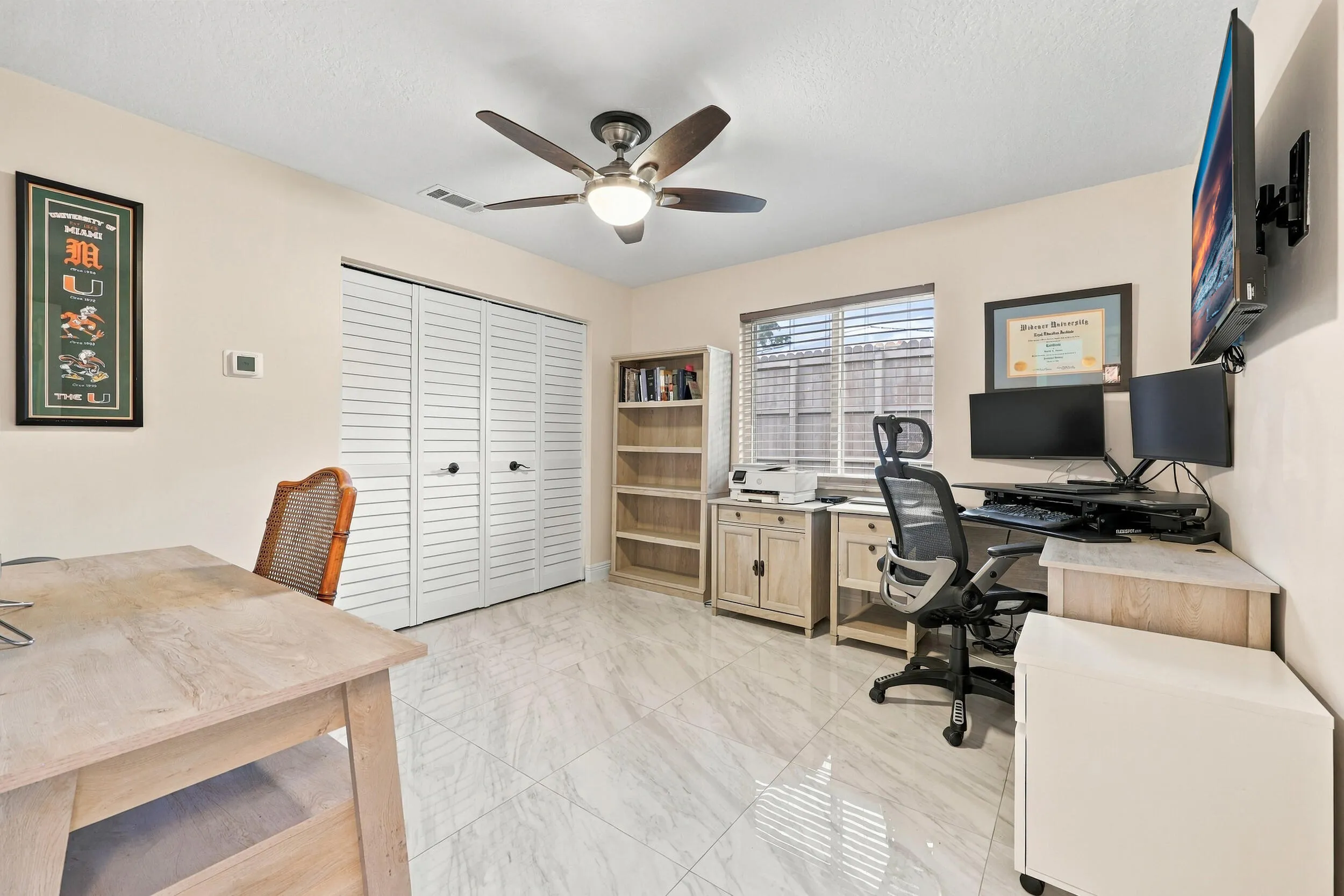 Guest bedroom 1 is spacious with large impact windows and ample closet space.