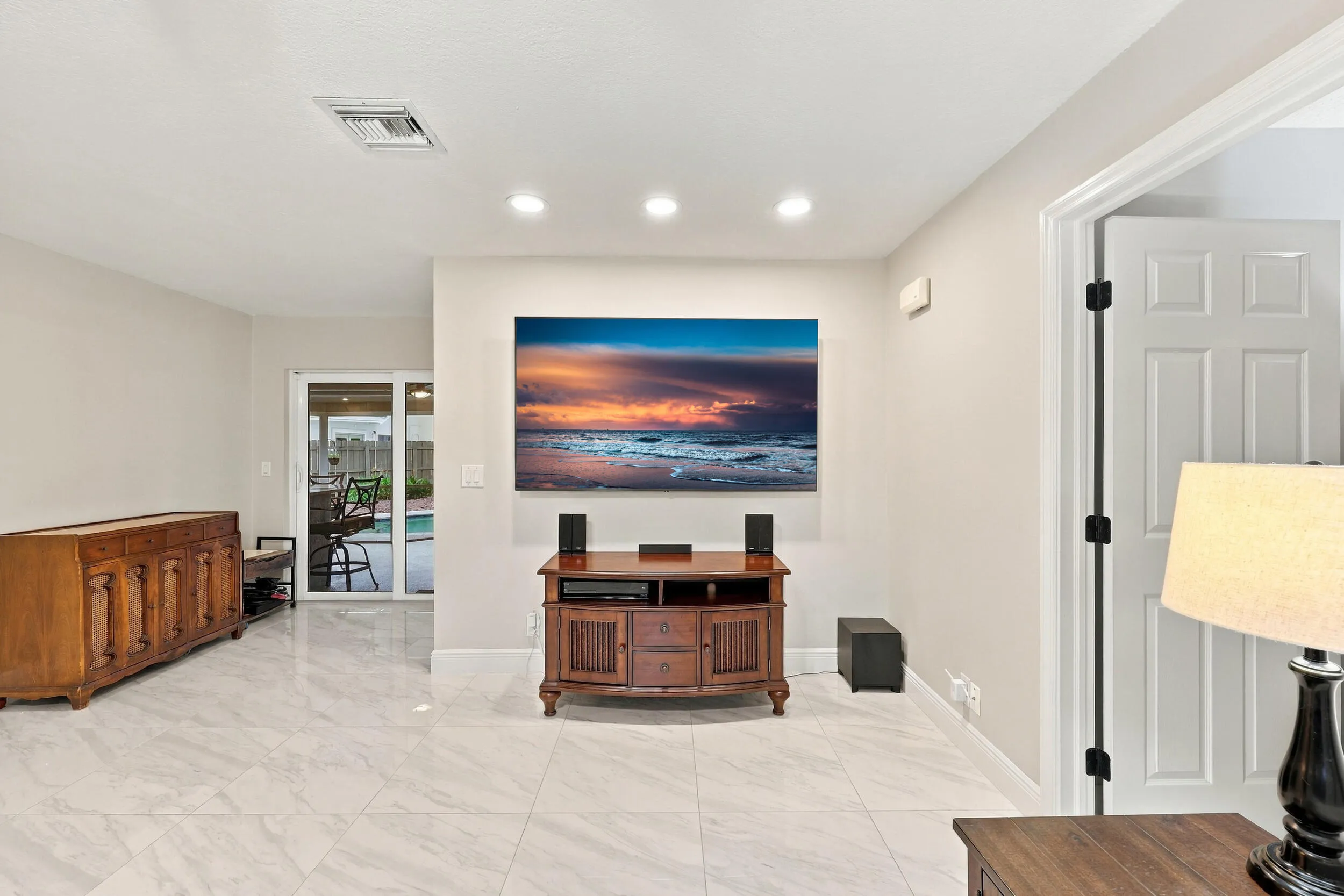 The family room is a versatile space for children of all ages. Relax and enjoy a separate area away from the kitchen and formal living room that also provides direct access through sliding glass doors to the covered patio and one-of-a-kind backyard.