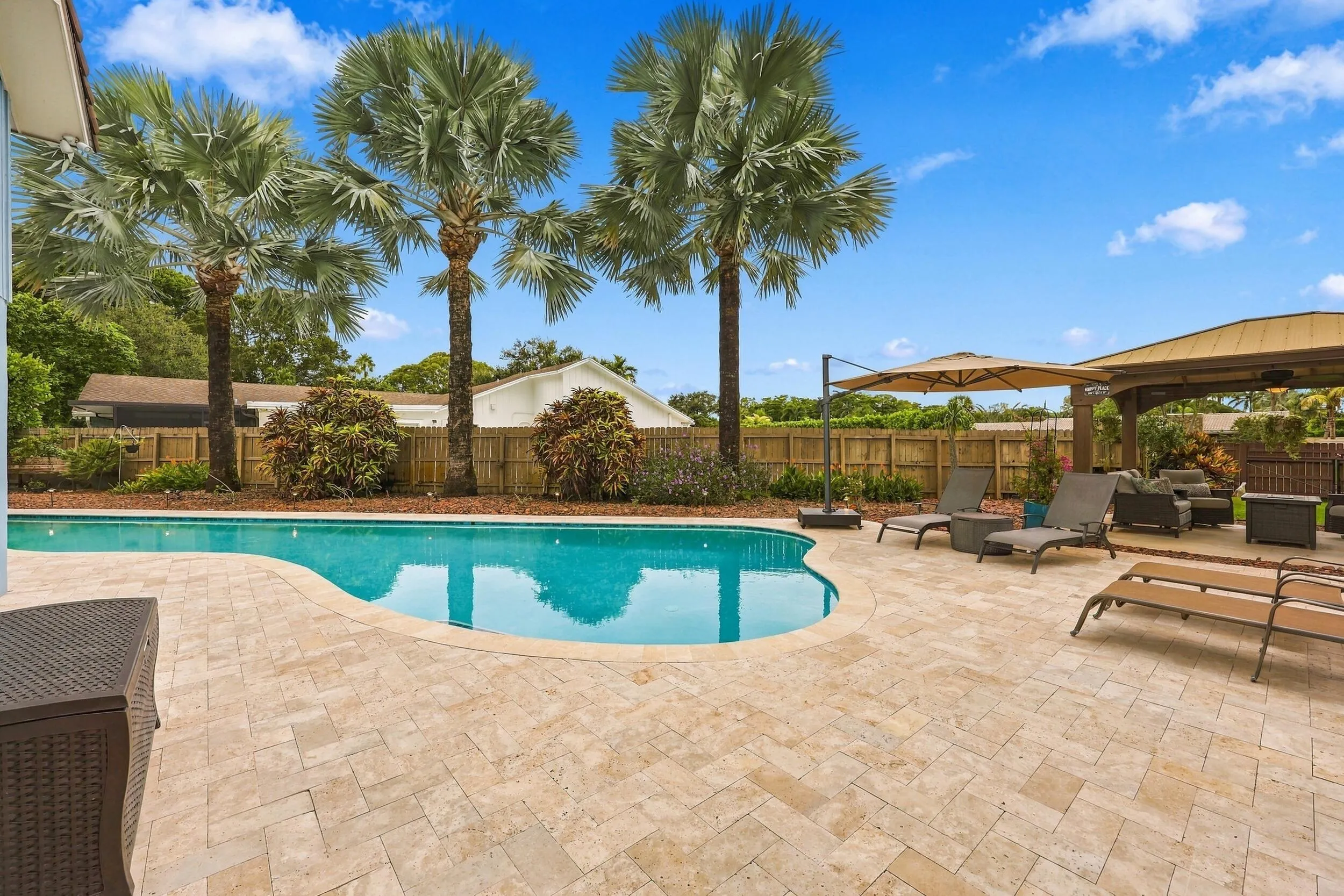 The resort-style pool starts underneath the roof line and expands down the oversized lot. Swim Olympic laps in your own backyard.