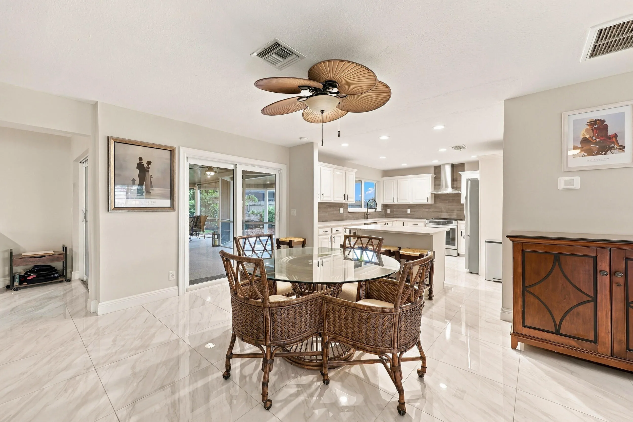 The dining space and eat-in kitchen are highlighted by new floors and a beautifully updated kitchen with quartz countertops and stainless steel appliances. Views of the resort-style pool can be seen from all areas of the house.
