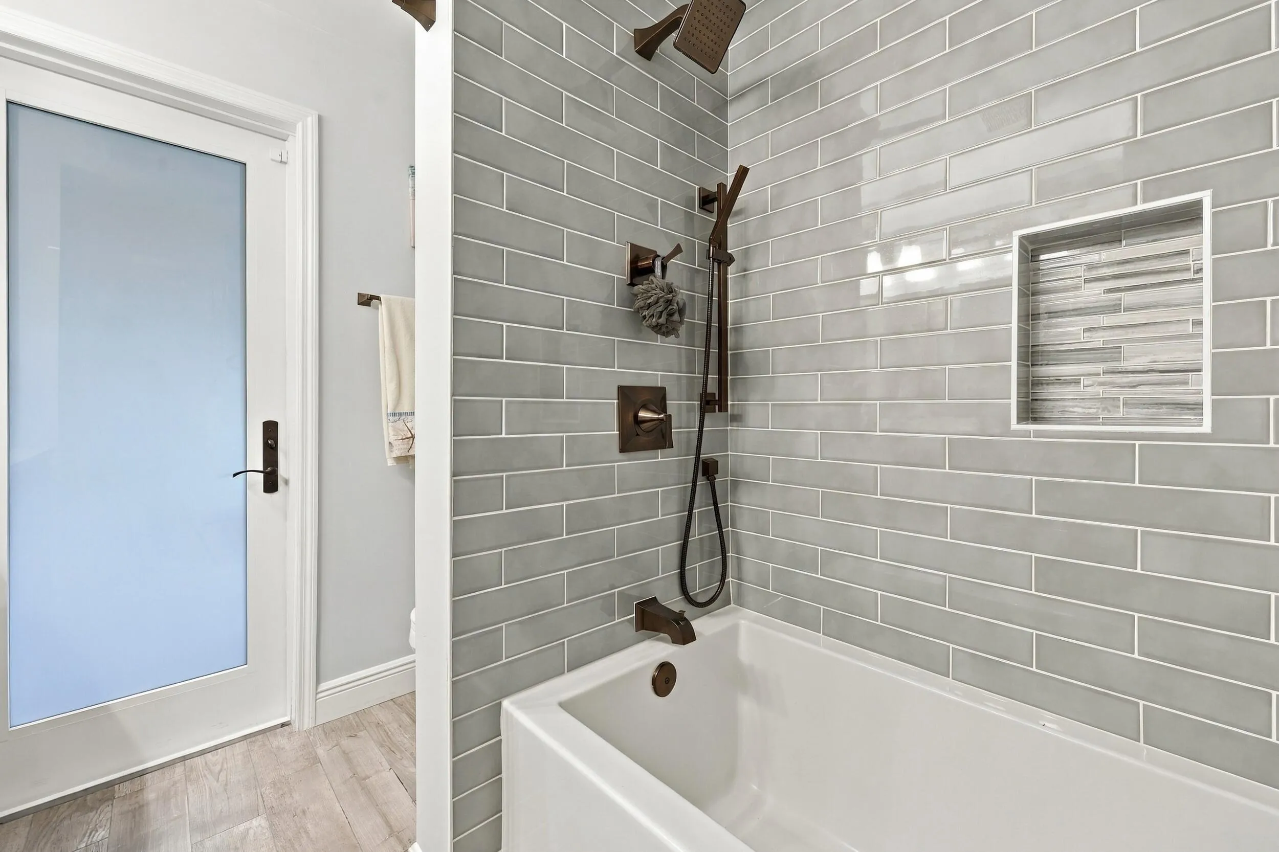 Bathroom 3 is a fully updated cabana bathroom with a new vanity, countertops, tile, and a tub and shower. Your guests will access it while spending days and evenings in the most beautiful backyard in Delray Beach.