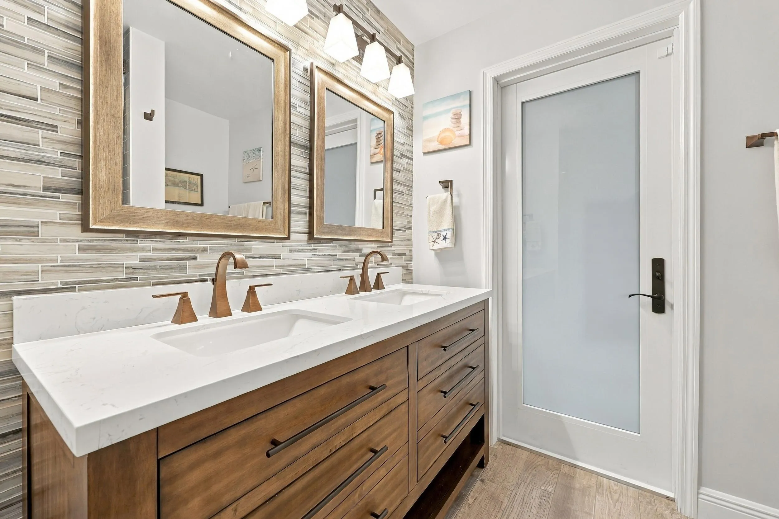Bathroom 3 is a fully updated cabana bathroom with a new vanity, countertops, tile, and a tub and shower. Your guests will access it while spending days and evenings in the most beautiful backyard in Delray Beach.