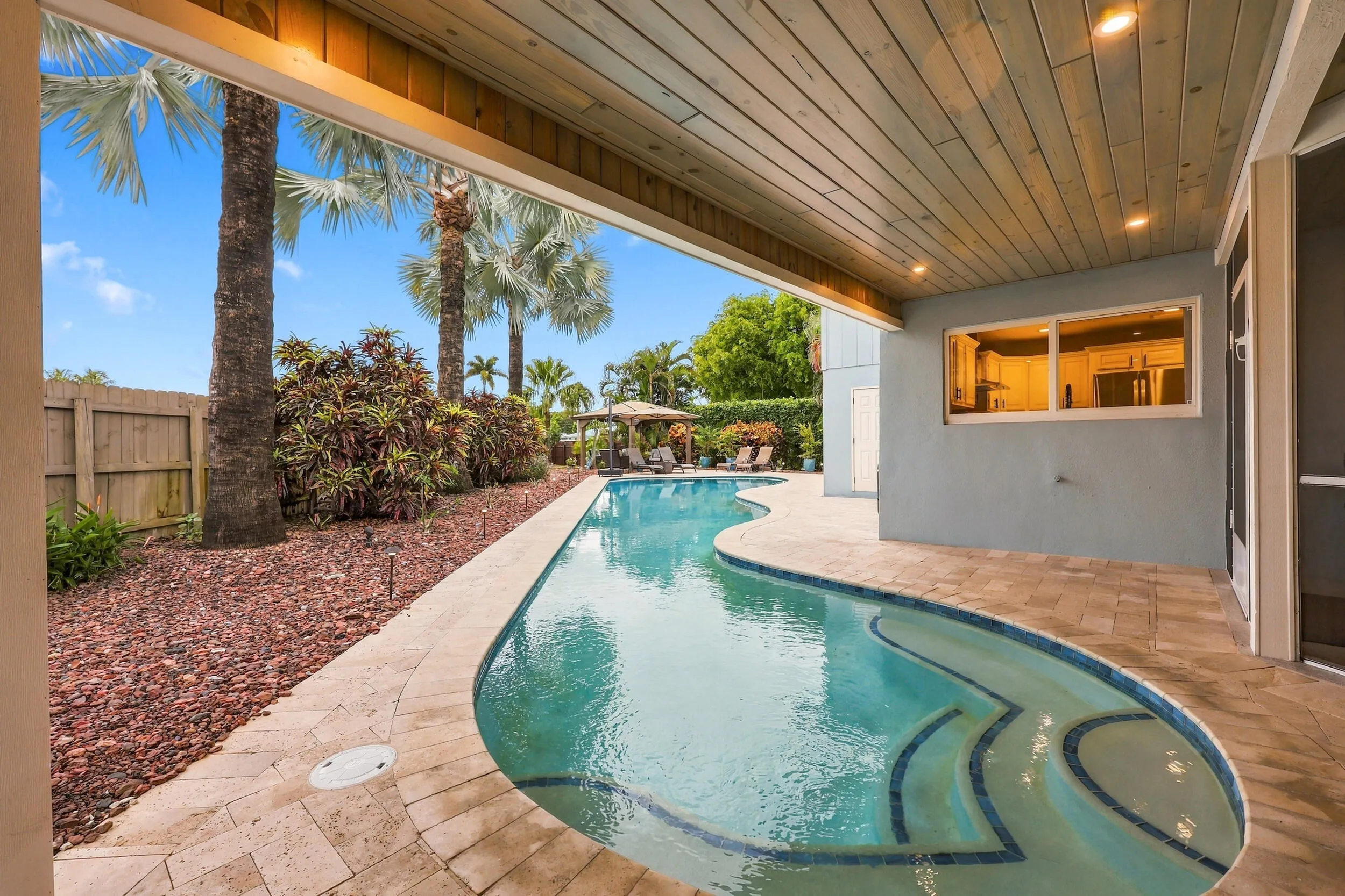 The resort-style pool starts underneath the roof line and expands down the oversized lot. Swim Olympic laps in your own backyard.