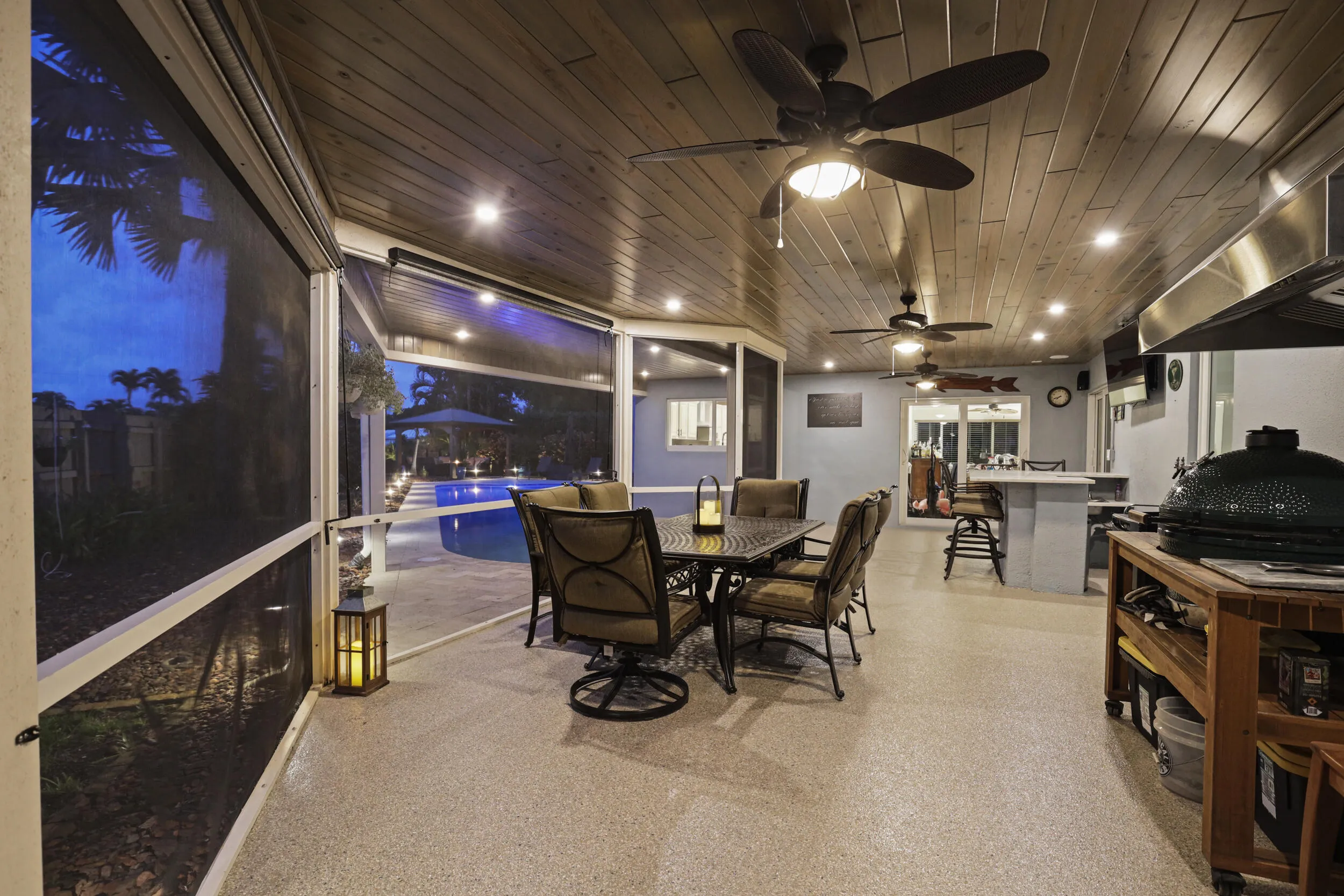 As evening approaches, the backyard comes alive with landscape lighting and a glowing resort-style pool.