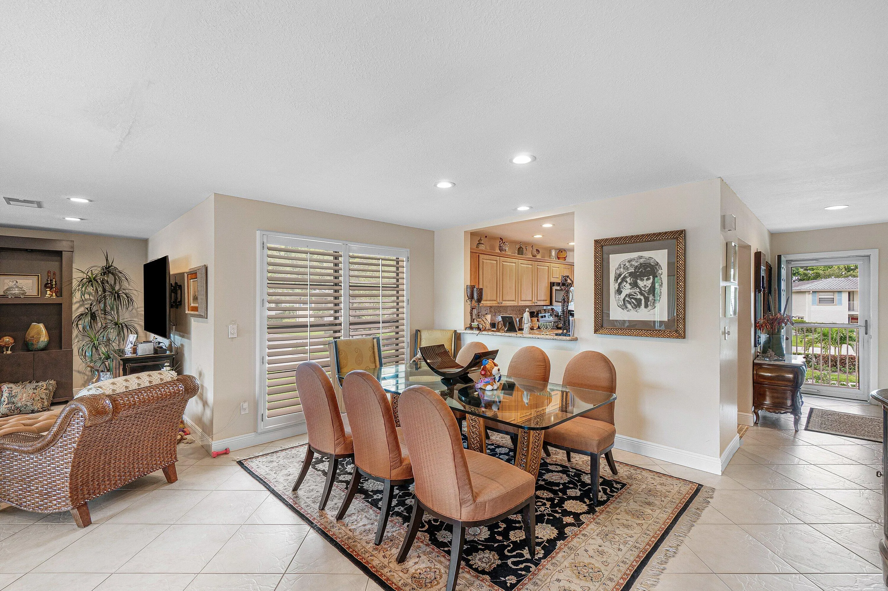 Recessed lighting, tile flooring, built-in shelving, kitchen pass-through window, and white plantation shutters