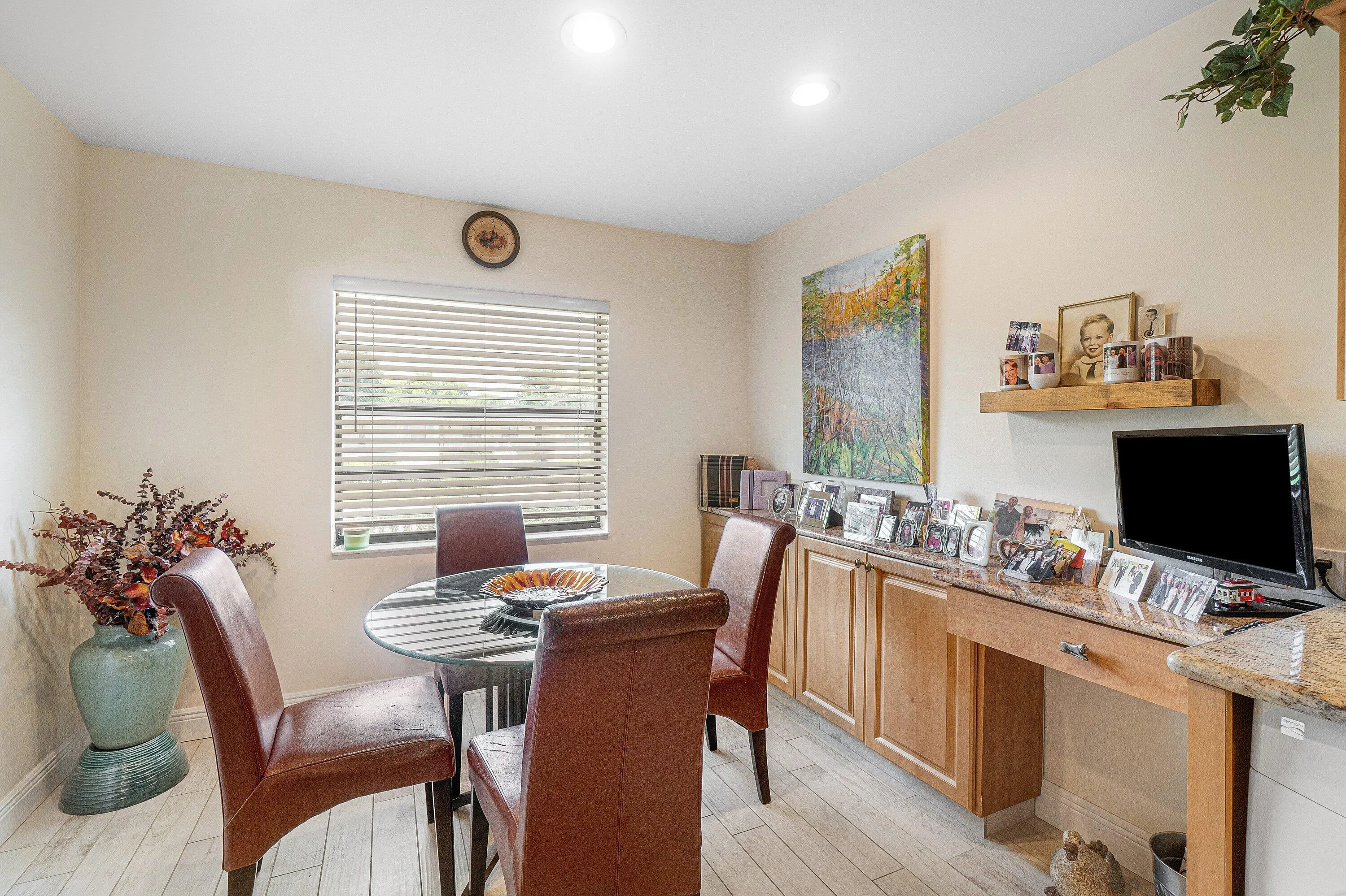 Recessed lighting, wood-finish flooring, built-in cabinetry, desk area, and window with blinds