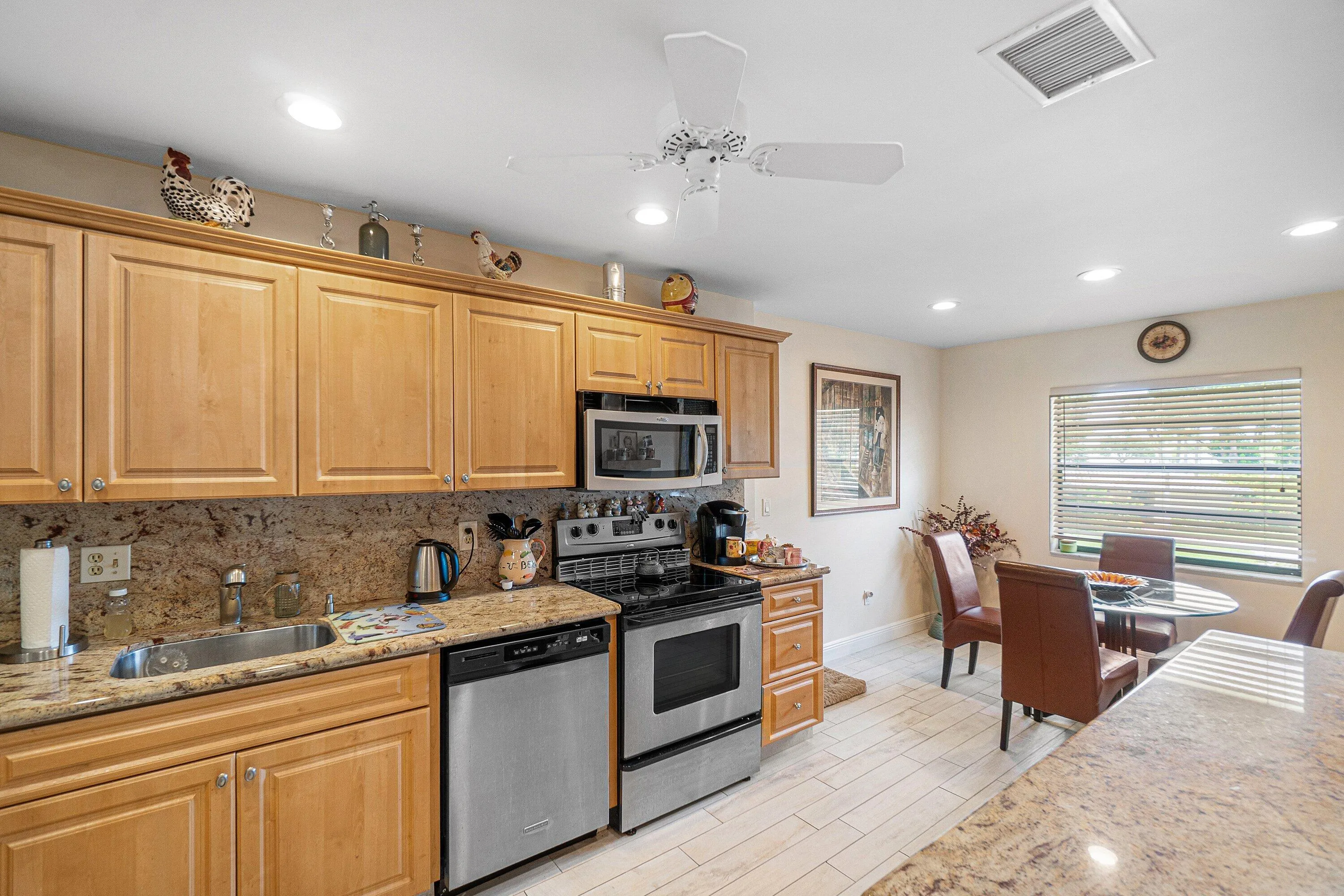 Kitchen featuring wood-finish cabinetry, granite countertops, and stainless steel appliances