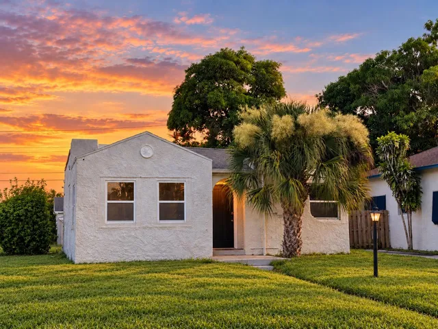 Charming main residence with classic Florida character, welcoming curb appeal and mature tropical landscaping.