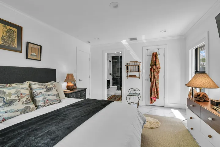 White walls with crown molding, recessed lighting, and a window with natural light
