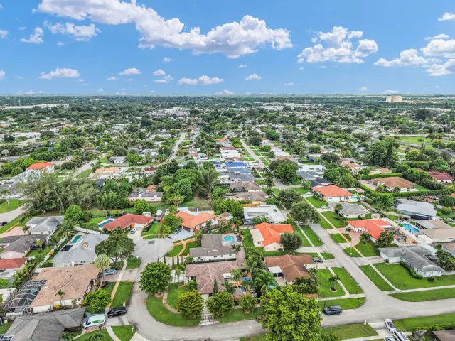 Aerial perspective showcasing a residential neighborhood with mature landscaping